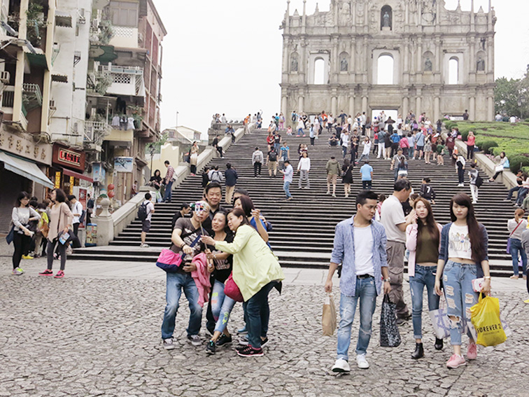 Visitors take a selfie in front of the UNESCO World Heritage-listed Ruins of Saint Paul’s Church