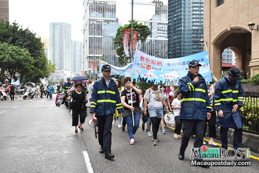 About 70 march to celebrate domestic violence law